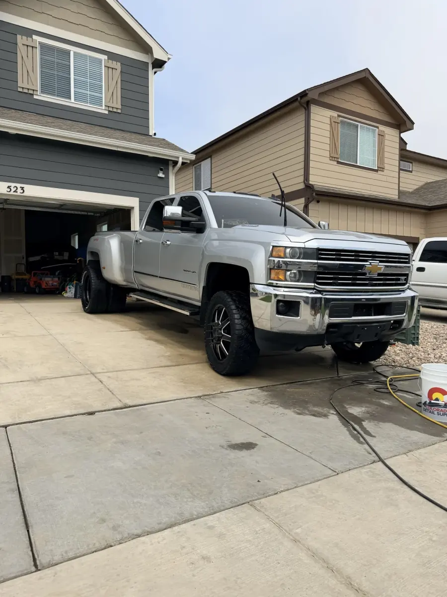 Silver Chevrolet Silverado finished in a customer driveway